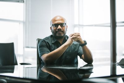 Image of Bimal Viswanath seated at a conference room table